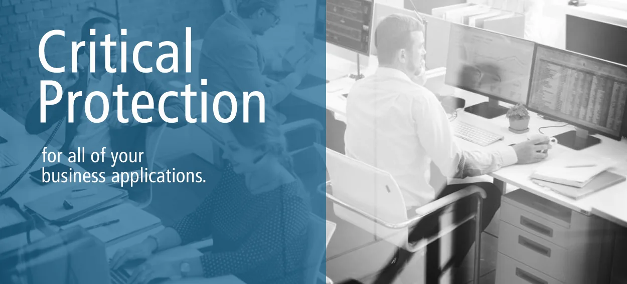 Office worker at a desk with the PowerShield message Critical Protection for all of your business applications