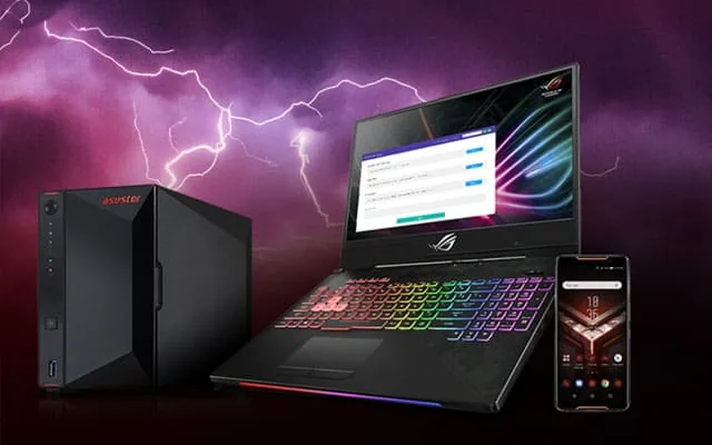 ASUSTOR NAS beside a gaming laptop and phone with RGB lighting