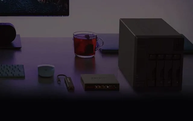 ASUSTOR NAS on a desk in a dark room