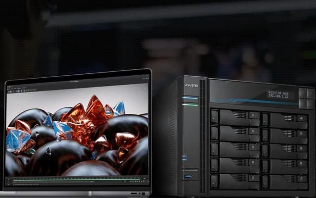 MacBook Pro editing footage beside an ASUSTOR Lockerstor rackmount NAS