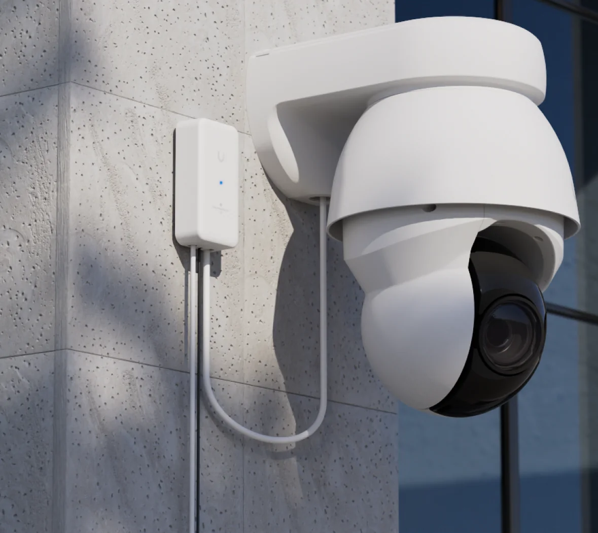 Ubiquiti Outdoor Long-Range Endpoint wall mounted beside a UniFi PTZ camera