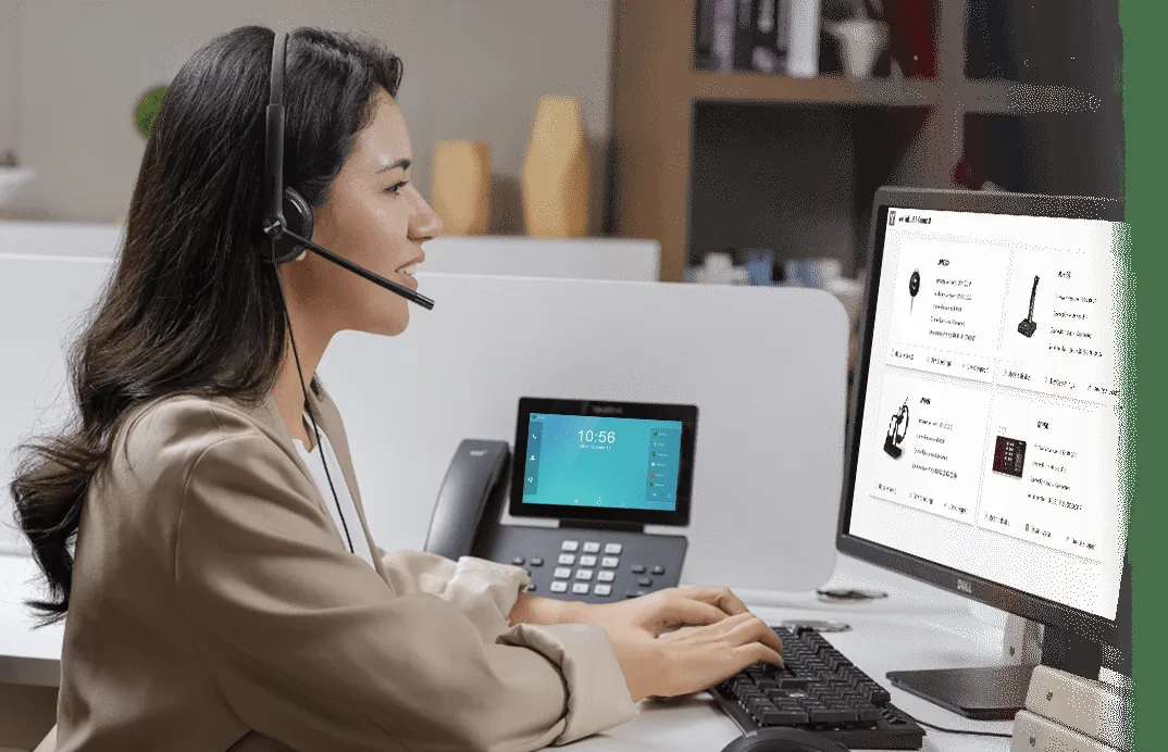 Call-centre agent wearing a Yealink UH34 wired headset at a desk with a Yealink phone