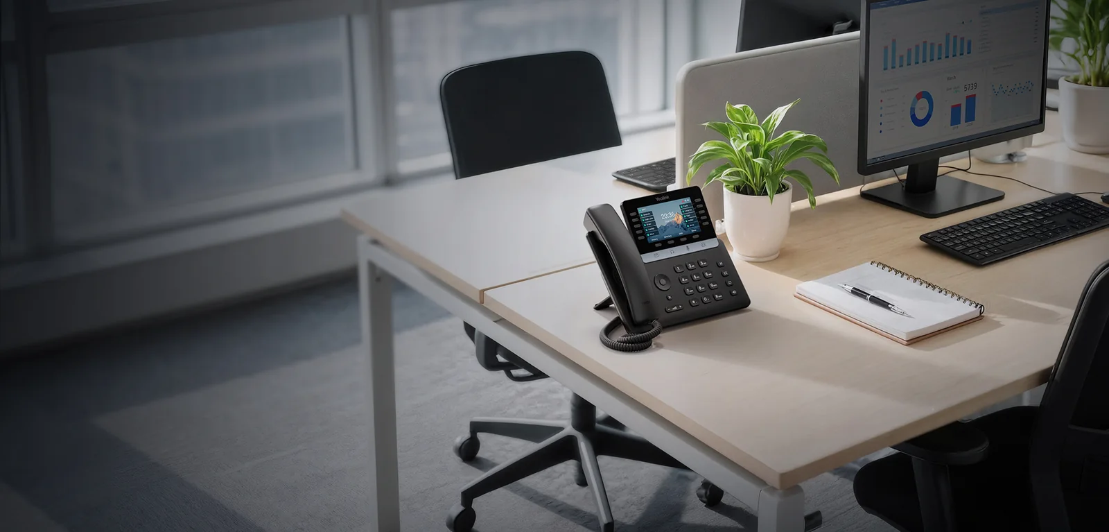 Yealink T7 Series IP phone with colour screen on a desk in an open-plan office