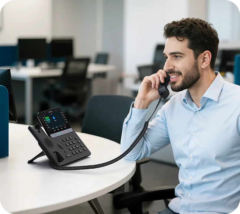 Man on a call at a Yealink SIP-T74W colour-screen IP phone