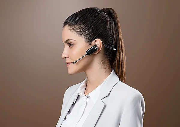 Woman wearing a Yealink convertible DECT headset on the neckband