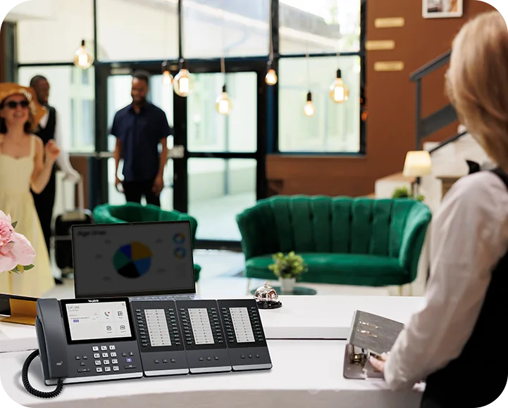 Yealink MP56 E2 Teams phone with three EXP50 expansion modules on a hotel reception desk