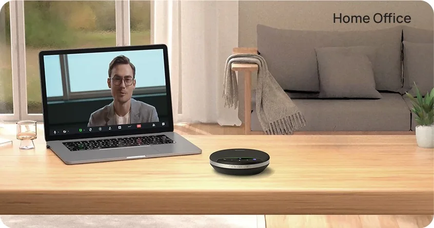 Yealink SP96 speakerphone next to a laptop on a home-office desk